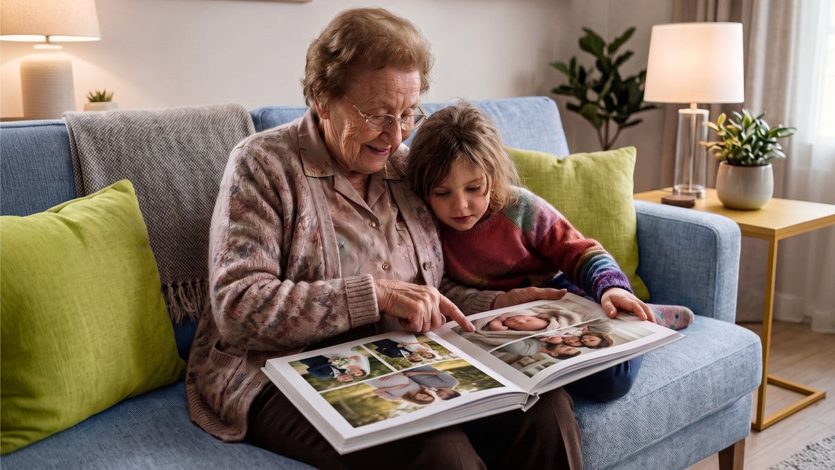Grandmother and granddaughter looking through a family photo book together on a blue sofa